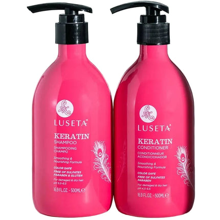 Two bright pink Luseta Keratin hair care bottles on a white surface with a blurred metal rack and light background behind them. The left bottle is Keratin Shampoo and the right bottle is Keratin Conditioner, both with black pump dispensers.