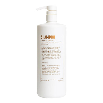 A large white plastic pump bottle of Hébés Paris Coconut Apricot Shampoo, featuring a minimalist label with brown text, set against a plain white background.